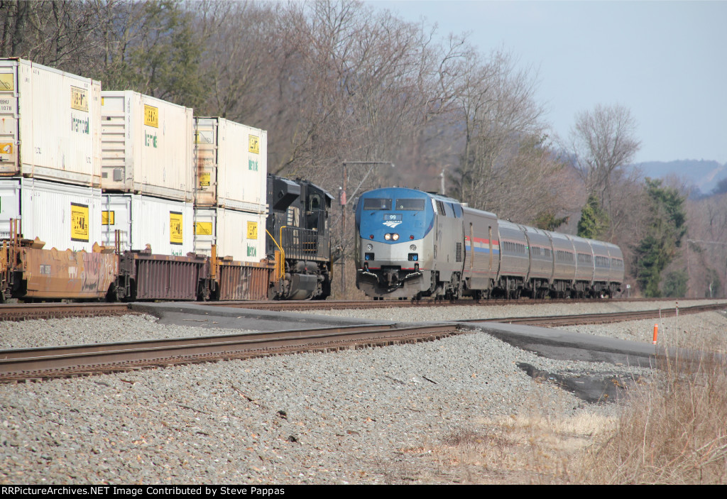 Amtrak 99 meets a stack train while taking train 07T west